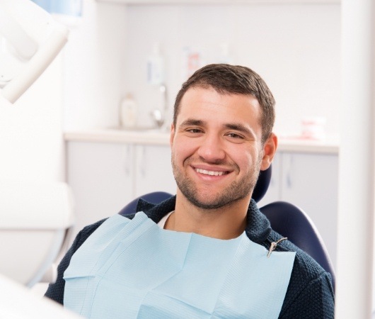 Man smiling in dental chair during preventive dentistry checkup