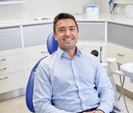 Smiling man sitting in dental chair