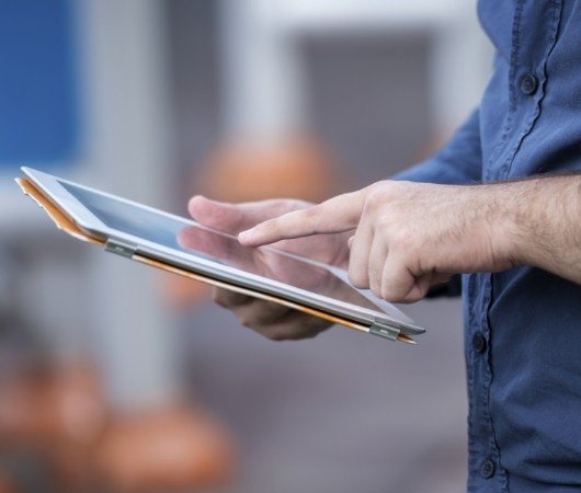 Person typing on tablet