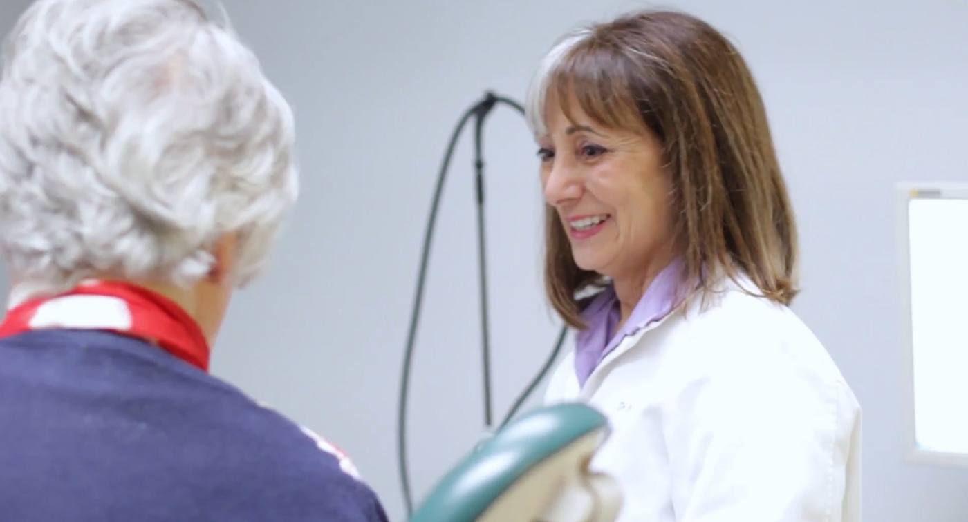 Derry New Hampshire dentist Brenda Berkal D M D talking to a patient