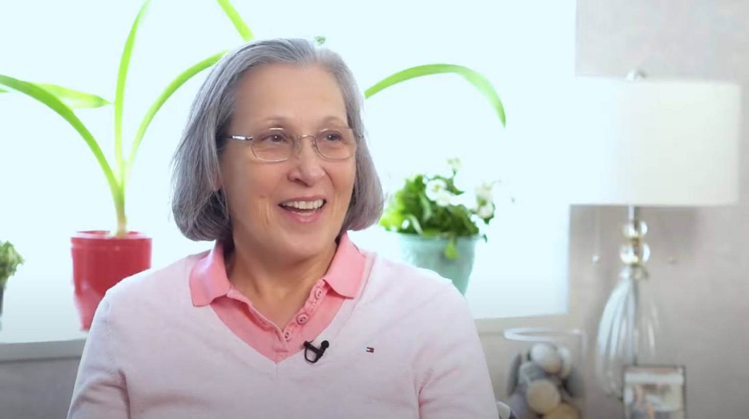 Senior woman in light pink sweater