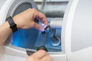 Dental team member working with CEREC machine 